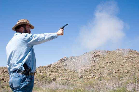 Image of the this pistol being fired with black
		    powder loads